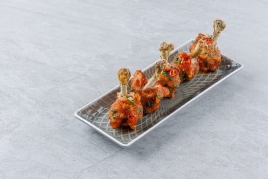chicken wings baked on a stone background studio food photo 2