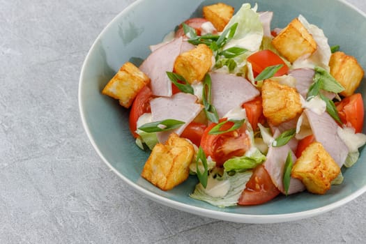 salad with ham and halloumi cheese on a stone background studio food photo 4