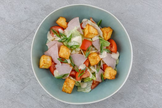 salad with ham and halloumi cheese on a stone background studio food photo 3