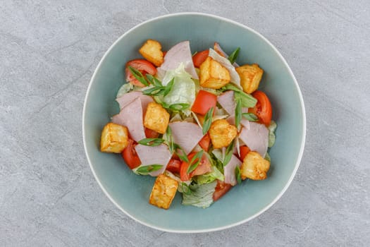 salad with ham and halloumi cheese on a stone background studio food photo 2