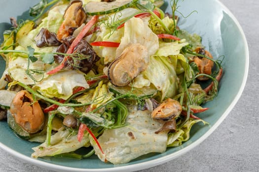salad with mussels and tree mushroom on a stone background studio food photo 2
