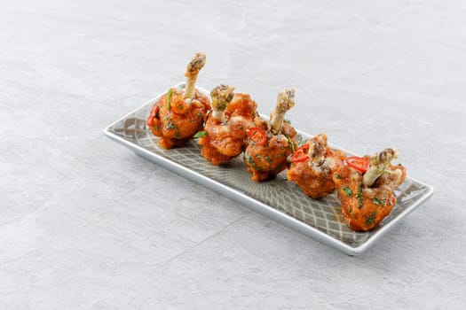 chicken wings baked on a stone background studio food photo 1