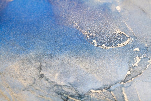 Blue and gold alcohol ink. Style incorporates the swirls of marble or the ripples of agate. Abstract painting, trendy background for wallpapers, posters, cards, invitations, websites.
