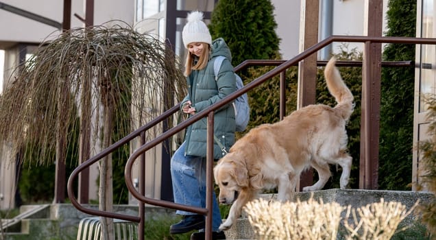 Girl With Golden Retriever Leaves House In Spring, Dog In City