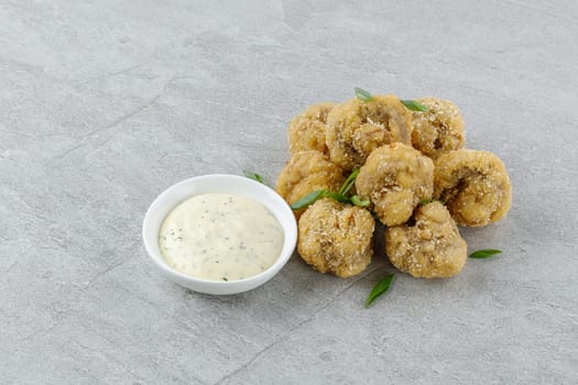 mushrooms in batter on a stone background studio food photo 2