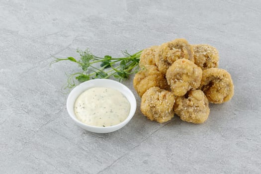 mushrooms in batter on a stone background studio food photo