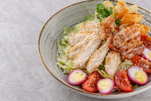 Caesar salad with chicken and bacon on a stone background studio food photo 5