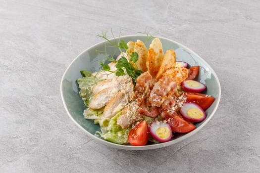 Caesar salad with chicken and bacon on a stone background studio food photo 4