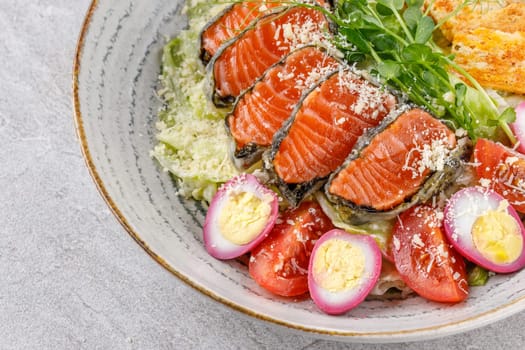 Caesar salad with baked salmon on a stone background studio food photo 4