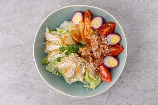 Caesar salad with chicken and bacon on a stone background studio food photo 3