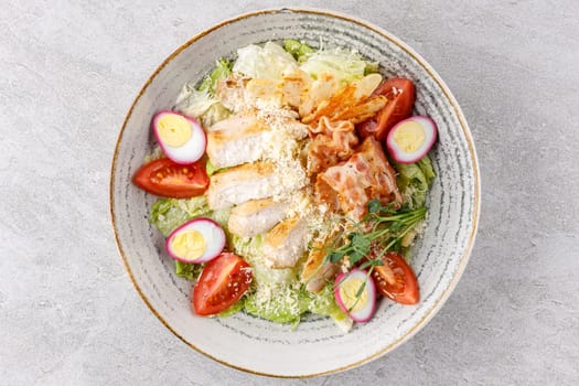 Caesar salad with chicken and bacon on a stone background studio food photo 2