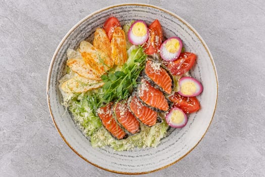 Caesar salad with baked salmon on a stone background studio food photo 2