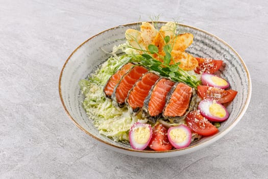 Caesar salad with baked salmon on a stone background studio food photo 1