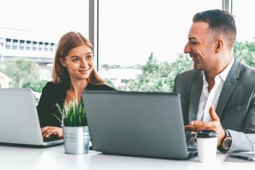 Businessman executive is in meeting discussion with a businesswoman worker in modern workplace office. People corporate business team concept. uds