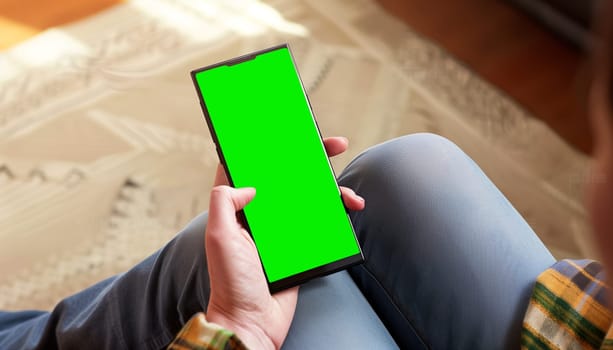 Mockup image of a business people holding smart mobile phone with blank green screen.