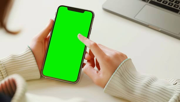 Mockup image of a business people holding smart mobile phone with blank green screen.