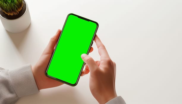 Mockup image of a business people holding smart mobile phone with blank green screen.