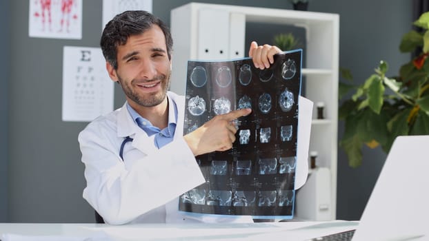 portrait of a male doctor looking at x-ray picture