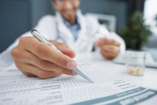 doctor making notes or recipe with pencil pen and paper for patient nurse close up.