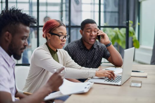 Young, motivated and experienced employees are brainstorming in the conference room.