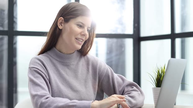 Close-up of a woman in the office working at a desk in the office.