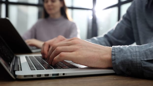 Working at a desk with a laptop in the office with a business team.