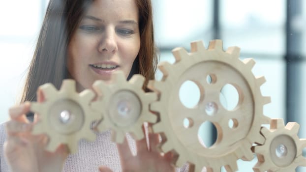 A woman in close-up in the office is thinking over a complex business plan.