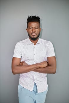 Serious dark skinned businessman has strict look, contemplates about new business project