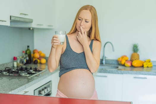 Weighing the pros and cons of milk during pregnancy, a thoughtful pregnant woman stands in the kitchen with a glass, contemplating the decision to include or avoid milk for her and her baby's well-being.