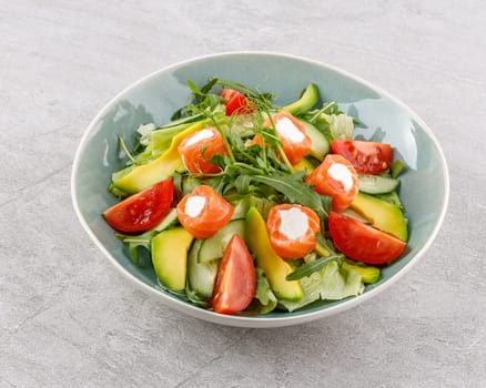salad with salmon and cream cheese on a stone background studio food photo