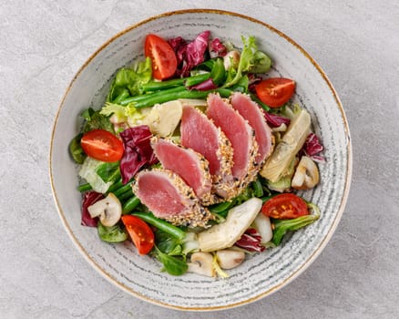 Tuna and artichoke salad on a stone background studio food photo 1