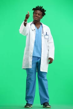 The doctor, in full height, on a green background, shows a thumbs up.