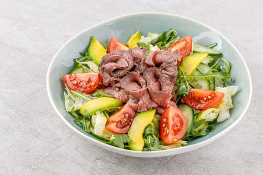 Salad with roast beef, avocado and tomatoes on a stone background studio food photo 8
