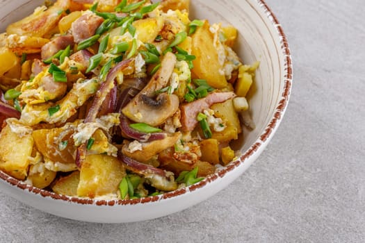 fried potatoes with mushrooms and ham on a stone background studio food photo 5
