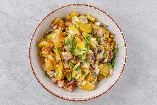fried potatoes with mushrooms and ham on a stone background studio food photo 4