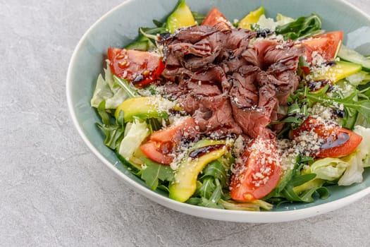 Salad with roast beef, avocado and tomatoes on a stone background studio food photo 3