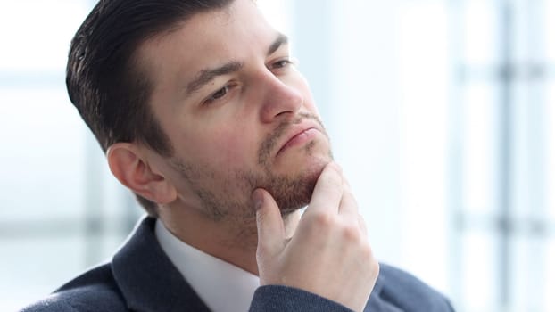 A businessman man working in the office in close-up.