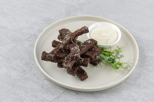 fried slices of black bread on a stone background studio food photo 3