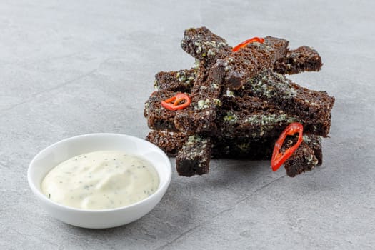 fried slices of black bread on a stone background studio food photo