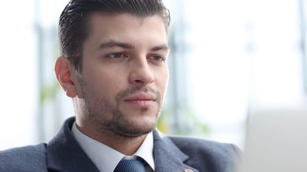 A male businessman works in an office.
