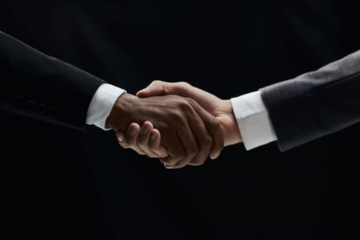African businessman's hand shaking white businessman's hand