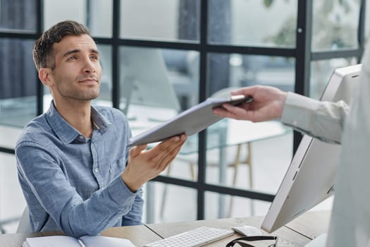 Confident businessman passing papers at meeting. Board meeting concept