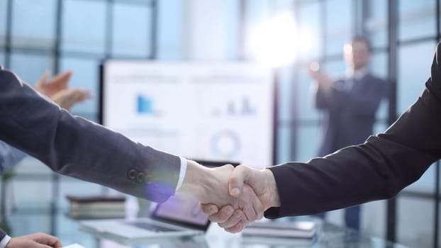 Congratulations on a successful deal with a handshake.