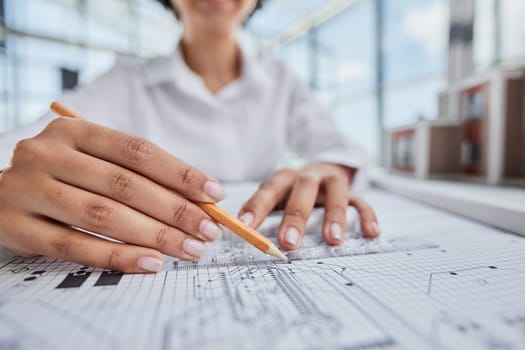 female architect designer working on blueprints at office