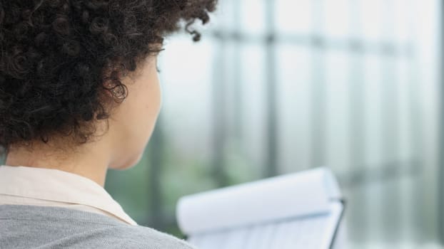 woman in the office looking through paper documents at office