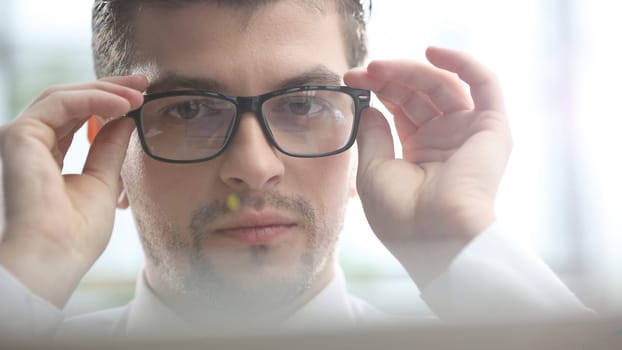 Male businessman in close-up working on a laptop.