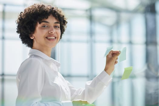 business woman mentor leader write tasks creative ideas on sticky post