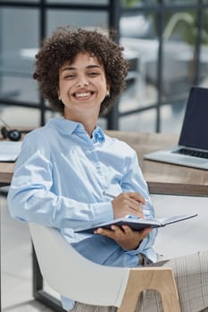 Smiling confident business leader looking at camera and standing in an office