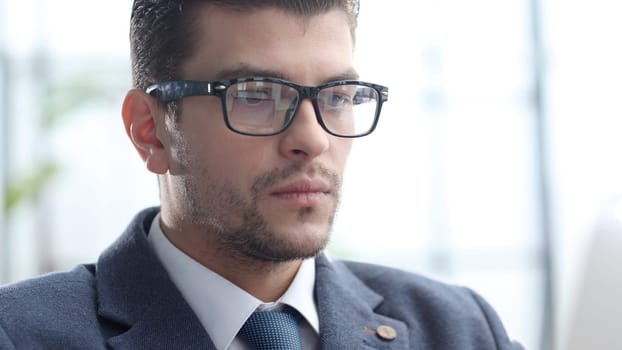 A male businessman works in an office.
