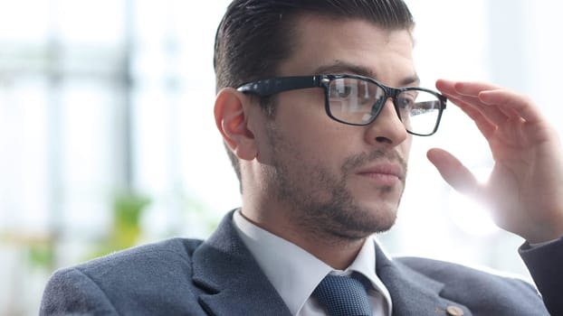Male businessman in close-up working on a laptop.